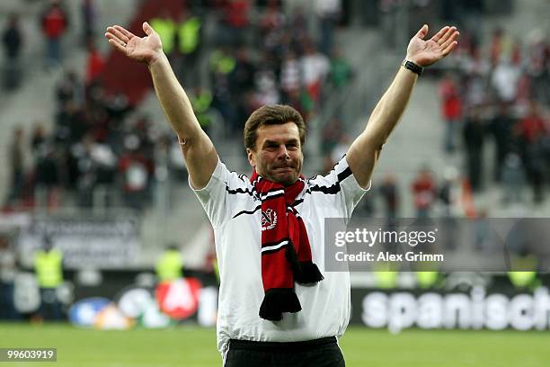 Head coach Dieter Hecking of Nuernberg celebrates with supporters after winning the Bundesliga play off leg two match between FC Augsburg and 1. FC...