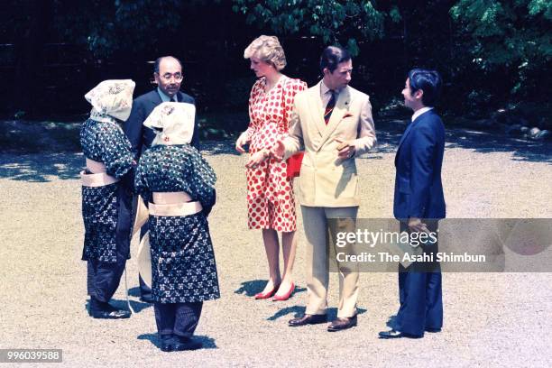 Prince Charles, Prince of Wales, Princess Diana, Princess of Wales and Prince Naruhito talk with female gardeners wearing traditional Oharame...