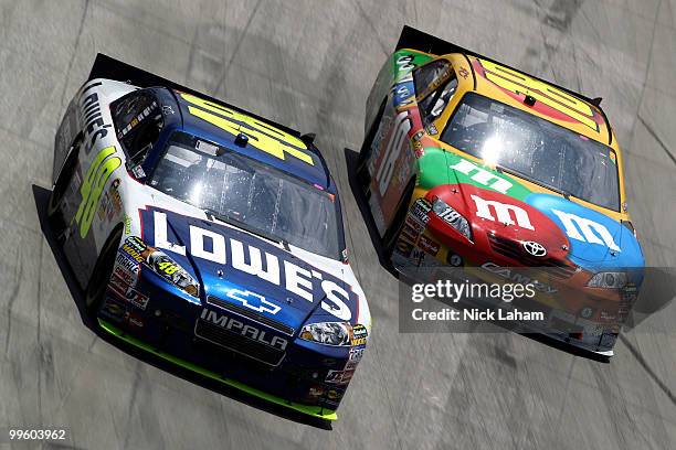 Jimmie Johnson, driver of the Lowe's Chevrolet, and Kyle Busch, driver of the M&M's Toyota, race side by side during the NASCAR Sprint Cup Series...