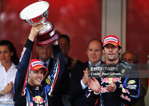 Sebastian Vettel of Germany and Red Bull Racing celebrates with the trophy for finishing second during the Monaco Formula One Grand Prix at the Monte...