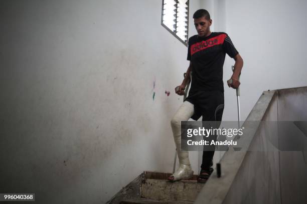 Palestinian Izzeddin Sahin who shot and wounded by Israeli forces during the protest within the "Great March of Return" demonstrations, walks...