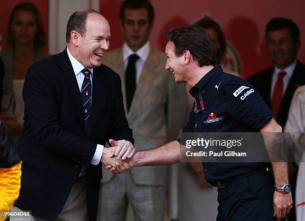 Red Bull Racing Team Principal Christian Horner is congratulated by Prince Albert II of Monaco following the Monaco Formula One Grand Prix at the...