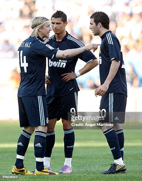 Jose Maria Gutierrez of Real Madrid chats with Cristiano Ronaldo and Gonzalo Higuain during the La Liga match between Malaga and Real Madrid at La...