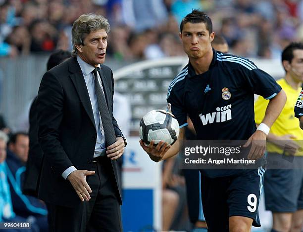 Head coach Manuel Pellegrini gives instructions to Cristiano Ronaldo during the La Liga match between Malaga and Real Madrid at La Rosaleda Stadium...