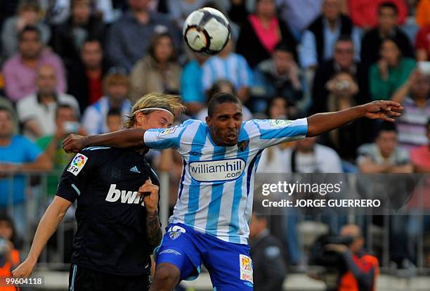 Real Madrid's midfielder Guti vies for the ball with Malaga's Denmark defender Patrick Jan Mtiliga during a Spanish league football match at Rosaleda...