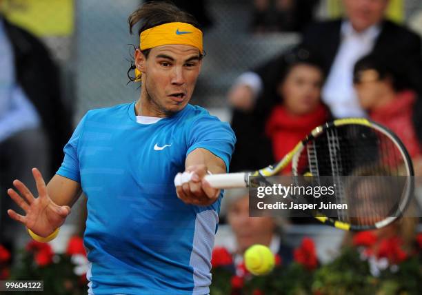 Rafael Nadal of Spain plays a backhand to Roger Federer of Switzerland in their final match during the Mutua Madrilena Madrid Open tennis tournament...