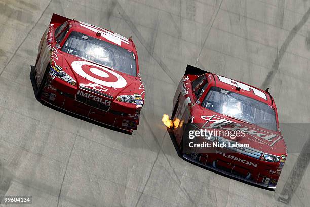 Juan Pablo Montoya, driver of the Target Chevrolet, and Kasey Kahne, driver of the Budweiser Ford, race side by side during the NASCAR Sprint Cup...