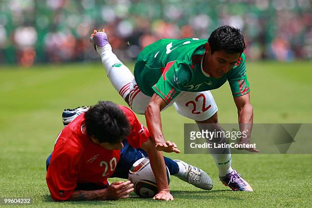 Alberto Medina of Mexico fights for the ball with Jaime Valdes of Chile during a friendly match as part of the Mexico National team preparation for...