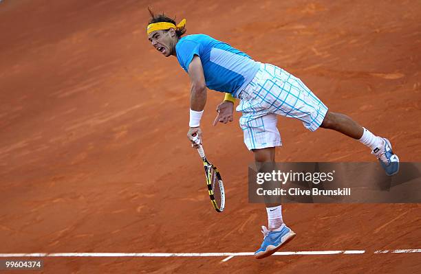 Rafael Nadal of Spain serves against Roger Federer of Switzerland in the mens final match during the Mutua Madrilena Madrid Open tennis tournament at...