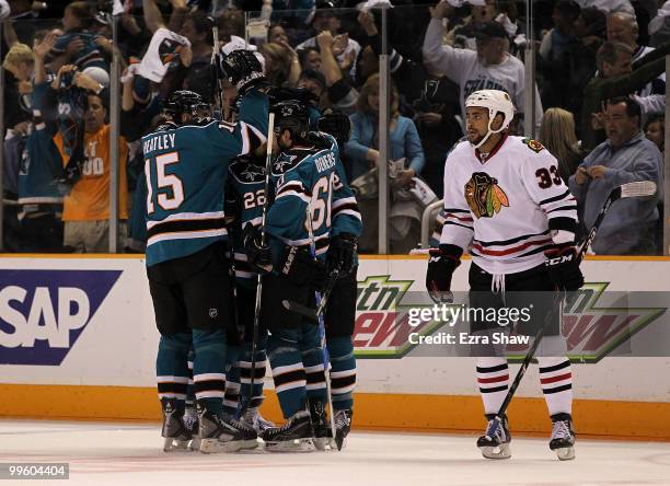 Jason Demers of the San Jose Sharks reacts with teammates Patrick Marleau, Dan Boyle and Joe Thornton after Demers scored a first period goal as...