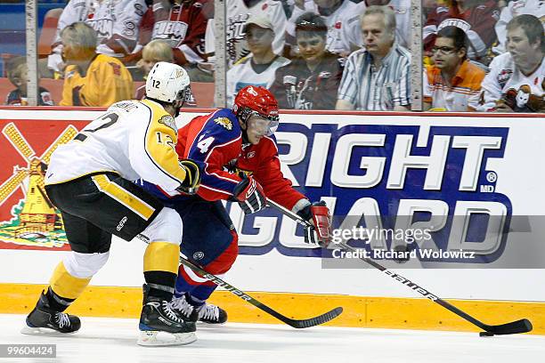 Gabriel Bourque of the Moncton Wildcats skates with the puck while being defended by Travis Hamonic of the Brandon Wheat Kings during the 2010...