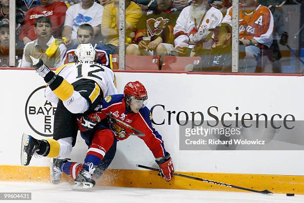 Travis Hamonic of the Brandon Wheat Kings body checks Gabriel Bourque of the Moncton Wildcats the 2010 Mastercard Memorial Cup Tournament at the...