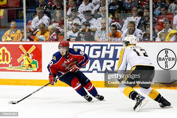 Kelsey Tessier of the Moncton Wildcats stick handles the puck in front of Travis Hamonic of the Brandon Wheat Kings during the 2010 Mastercard...