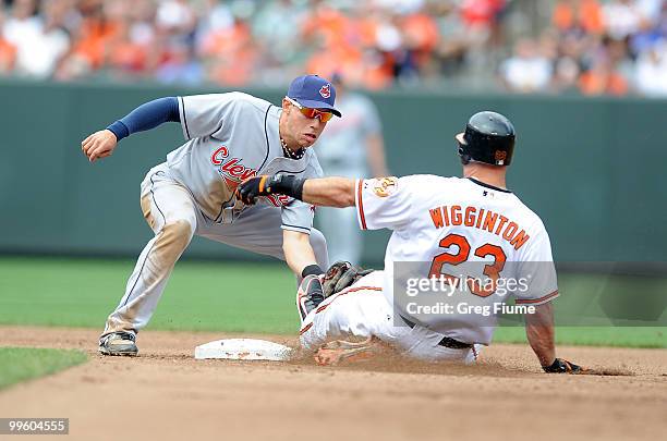 Ty Wigginton of the Baltimore Orioles is tagged out trying to stretch a single into a double by Asdrubal Cabrera of the Cleveland Indians at Camden...