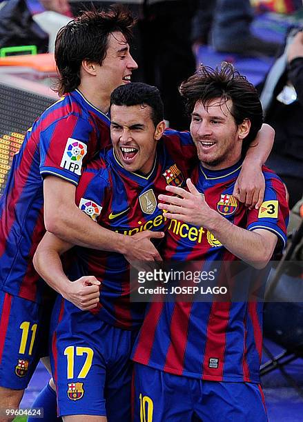 Barcelona's forward Pedro Rodriguez is congratuled by his teammates forward Bojan Krkic and Argentinian forward Lionel Messi after scoring during a...
