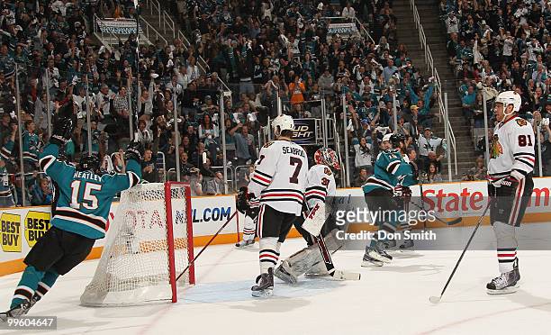 Brent Seabrook, Marian Hossa and Antti Niemi of the Chicago Blackhawks and Dany Heatley and Joe Thornton of the San Jose Sharks react to a goal in...
