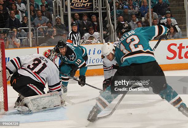 Antti Niemi of the Chicago Blackhawks watches Joe Thornton and Patrick Marleau of the San Jose Sharks in Game One of the Western Conference Finals...