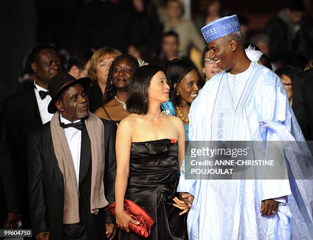 Actor Marius Yelolo, actress Heling Li and Chadian actor Youssouf Djaoro arrive for the screening of "Un Homme Qui Crie" presented in competition at...