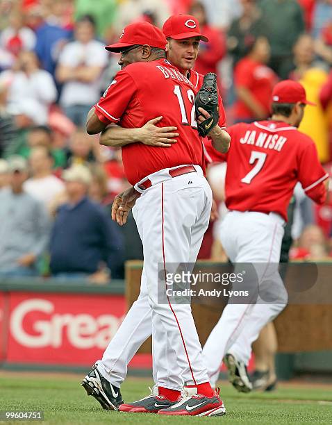 Bronson Arroyo of the Cincinnati Reds hugs manager Dusty Baker after pitching a complete game against the St. Louis Cardinals at Great American Ball...