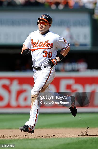 Luke Scott of the Baltimore Orioles rounds the bases after hitting a home run in the ninth inning against the Cleveland Indians at Camden Yards on...