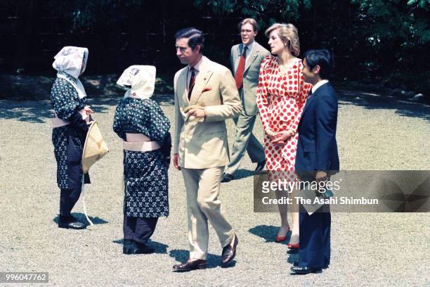Prince Charles, Prince of Wales, Princess Diana, Princess of Wales and Prince Naruhito talk with female gardeners wearing traditional Oharame...