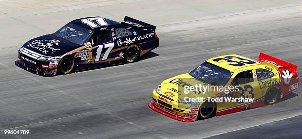 Matt Kenseth, driver of the Crown Royal Black Ford, and Clint Bowyer, driver of the Cheerios/Hamburger Helper Chevrolet, race side by side during the...