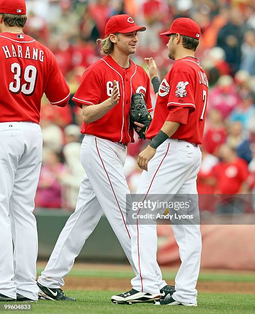 Bronson Arroyo of the Cincinnati Reds is congratulated after pitching a complete game against the St. Louis Cardinals at Great American Ball Park on...