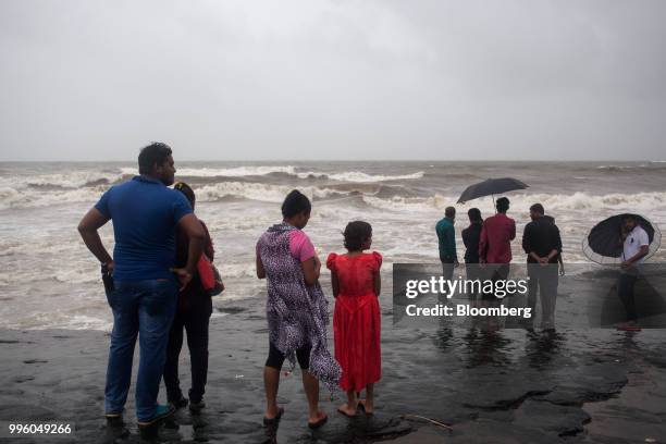 People look out to sea from the shoreline in the suburb of Bandra in Mumbai, India, on Tuesday, July 10, 2018. The monsoon is the lifeline of Asia's...