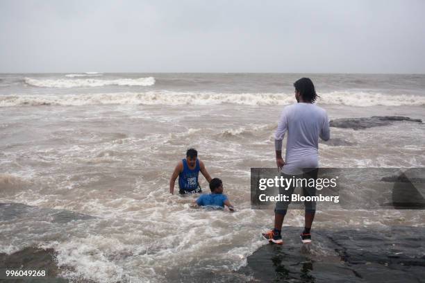 People gather at the shoreline in the suburb of Bandra in Mumbai, India, on Tuesday, July 10, 2018. The monsoon is the lifeline of Asia's...