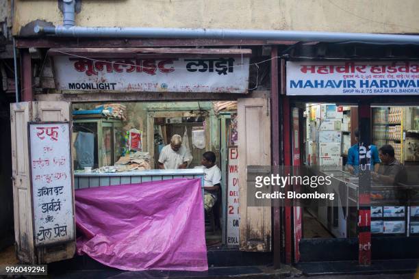 Tailor's store stands covered in a tarp in the suburb of Bandra in Mumbai, India, on Tuesday, July 10, 2018. The monsoon is the lifeline of Asia's...
