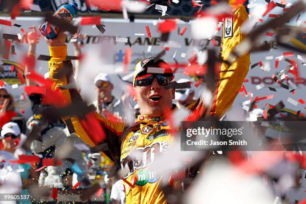 Kyle Busch, driver of the M&M's Toyota, celebrates in Victory Lane after winning the NASCAR Sprint Cup Series Autism Speaks 400 at Dover...