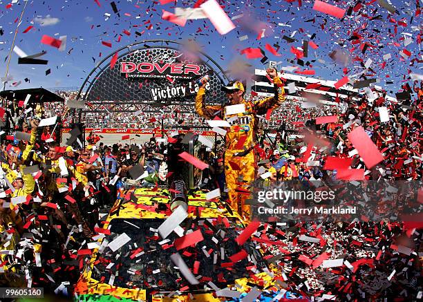 Kyle Busch, driver of the M&M's Toyota, celebrates in Victory Lane after winning the NASCAR Sprint Cup Series Autism Speaks 400 at Dover...