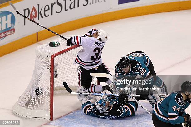 Dustin Byfuglien of the Chicago Blackhawks crashes into the net and goaltender Evgeni Nabokov of the San Jose Sharks in the first period of Game One...