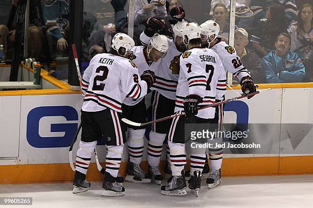 Patrick Sharp of the Chicago Blackhawks reacts with teammates Duncan Keith, Marian Hossa, Troy Brouwer and Brent Seabrook after Sharp's second period...