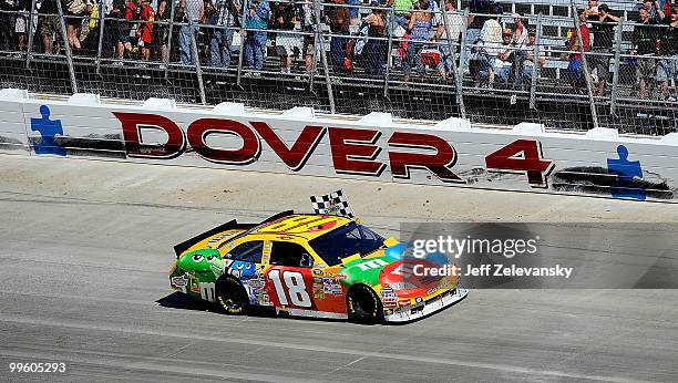 Kyle Busch, driver of the M&M's Toyota, performs a burnout after winning the NASCAR Sprint Cup Series Autism Speaks 400 at Dover International...