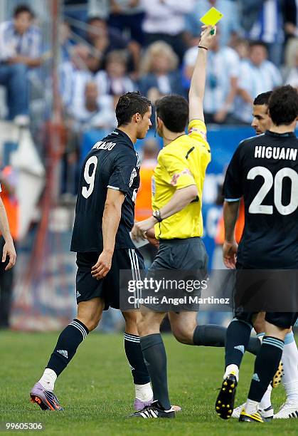 Referee Alberto Undiano Mallenco shows the yellow card to Cristiano Ronaldo of Real Madrid during the La Liga match between Malaga and Real Madrid at...