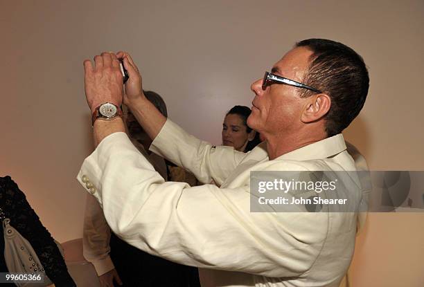 Actor Jean-Claude Van Damme takes a picture at the Variety Celebrates Ashok Amritraj event held at the Martini Terraza during the 63rd Annual...