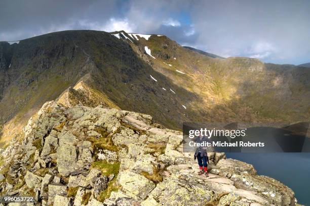 hiker on striding edge and helvellyn in the lake district national park - ambleside stock pictures, royalty-free photos & images