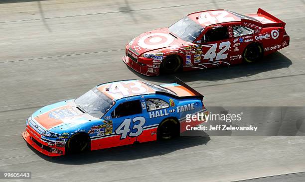 Allmendinger, driver of the Richard Petty Hall of Fame Ford, races with Juan Pablo Montoya, driver of the Target Chevrolet, during the NASCAR Sprint...