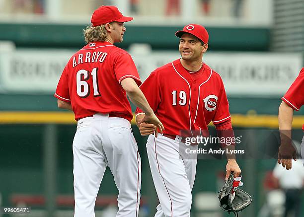 Bronson Arroyo of the Cincinnati Reds is congratulated by Joey Votto after pitching a complete game against the St. Louis Cardinals at Great American...