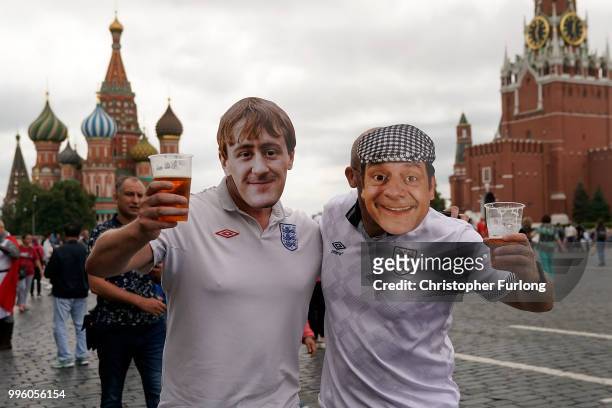England fans wearing Rodney and Dell Boy masks pose in Red Square ahead of tonight's World Cup semi-final game between England and Croatia on July...