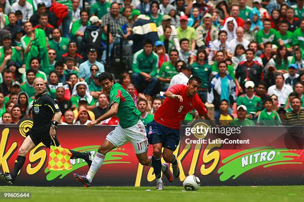 Carlos Vela of Mexico fights for the ball with Arturo Vidal of Chile, during a friendly match as part of the Mexico National team preparation for the...
