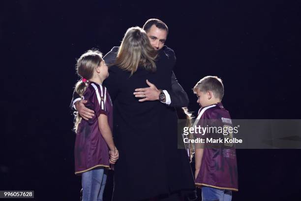 Cameron Smith hugs his family as he appears on stage during a "We love Queenslanders" Captain's Tribute during game three of the State of Origin...