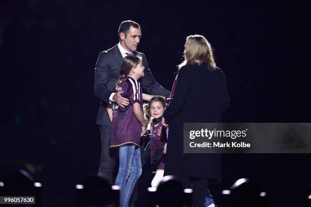 Cameron Smith hugs his family as he appears on stage during a "We love Queenslanders" Captain's Tribute during game three of the State of Origin...