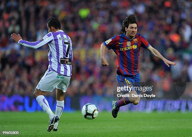 Lionel Messi of Barcelona beats gets past Nauzet Aleman of Real Valladolid during the La Liga match between Barcelona and Real Valladolid at Camp Nou...