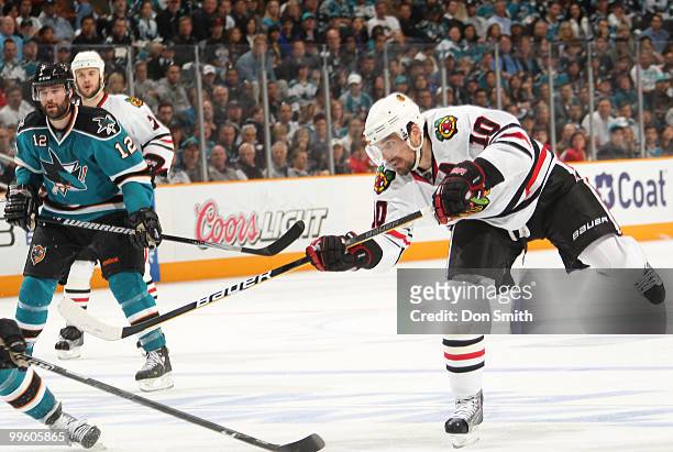 Patrick Sharp of the Chicago Blackhawks scores a goal against Patrick Marleau and the San Jose Sharks in Game One of the Western Conference Finals...