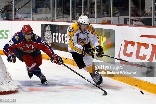Brayden Schenn of the Brandon Wheat Kings skates with the puck while being defended by David Savard of the Moncton Wildcats during the 2010...