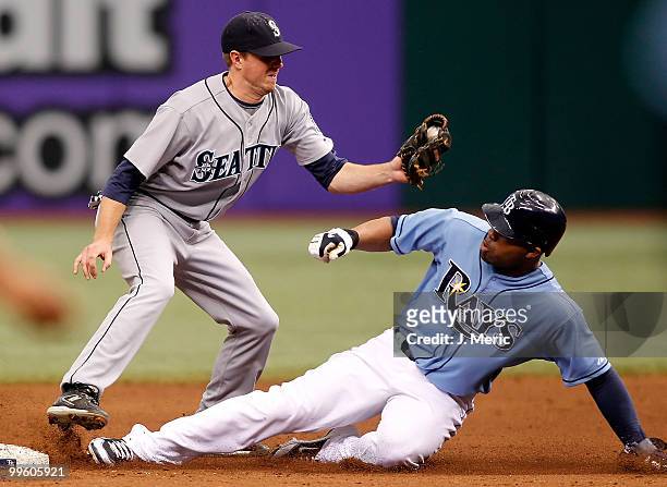 Outfielder Carl Crawford of the Tampa Bay Rays steals second base as shortstop Josh Wilson of the Seattle Mariners takes the throw during the game at...