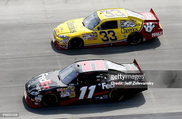 Denny Hamlin, driver of the FedEx Freight Toyota races with Clint Bowyer, driver of the Cheerios/Hamburger Helper Chevrolet during the NASCAR Sprint...