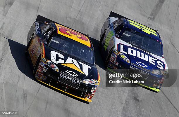 Jeff Burton, driver of the Caterpillar Chevrolet, and Jimmie Johnson, driver of the Lowe's Chevrolet, race side by side during the NASCAR Sprint Cup...
